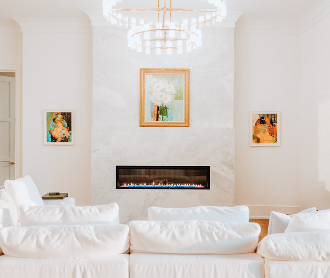 View of a living room with fireplace and white couches